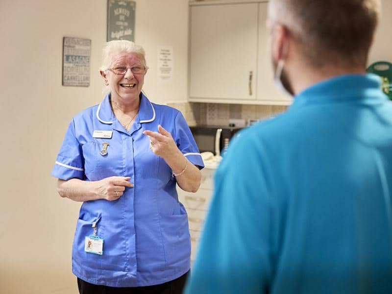 Nurse chatting to another colleague