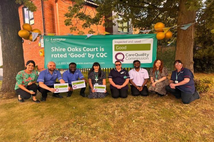 Shire Oaks COurt colleagues knelt down in front of a banner which states "rated good"